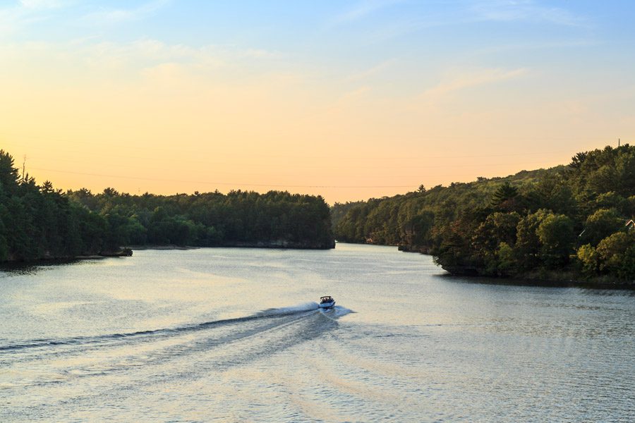 About Our Agency - Speed Boat Driving Along Rivers in WI at Sunset