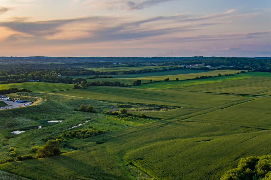 Capital-Richter Insurance Services - View of a WI Farmland at Sunset with Bright Green Grass